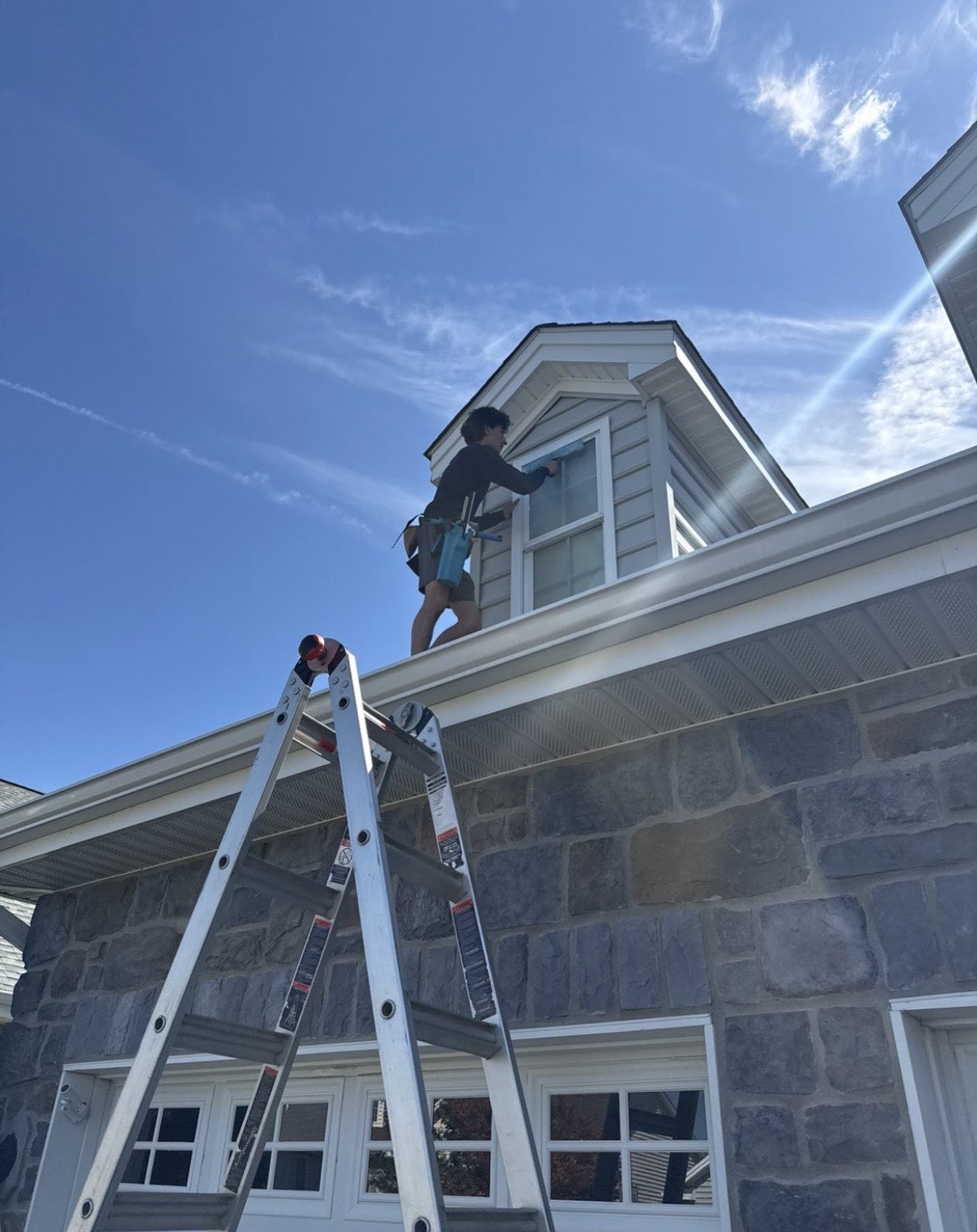 BDB technician cleaning a second-story window